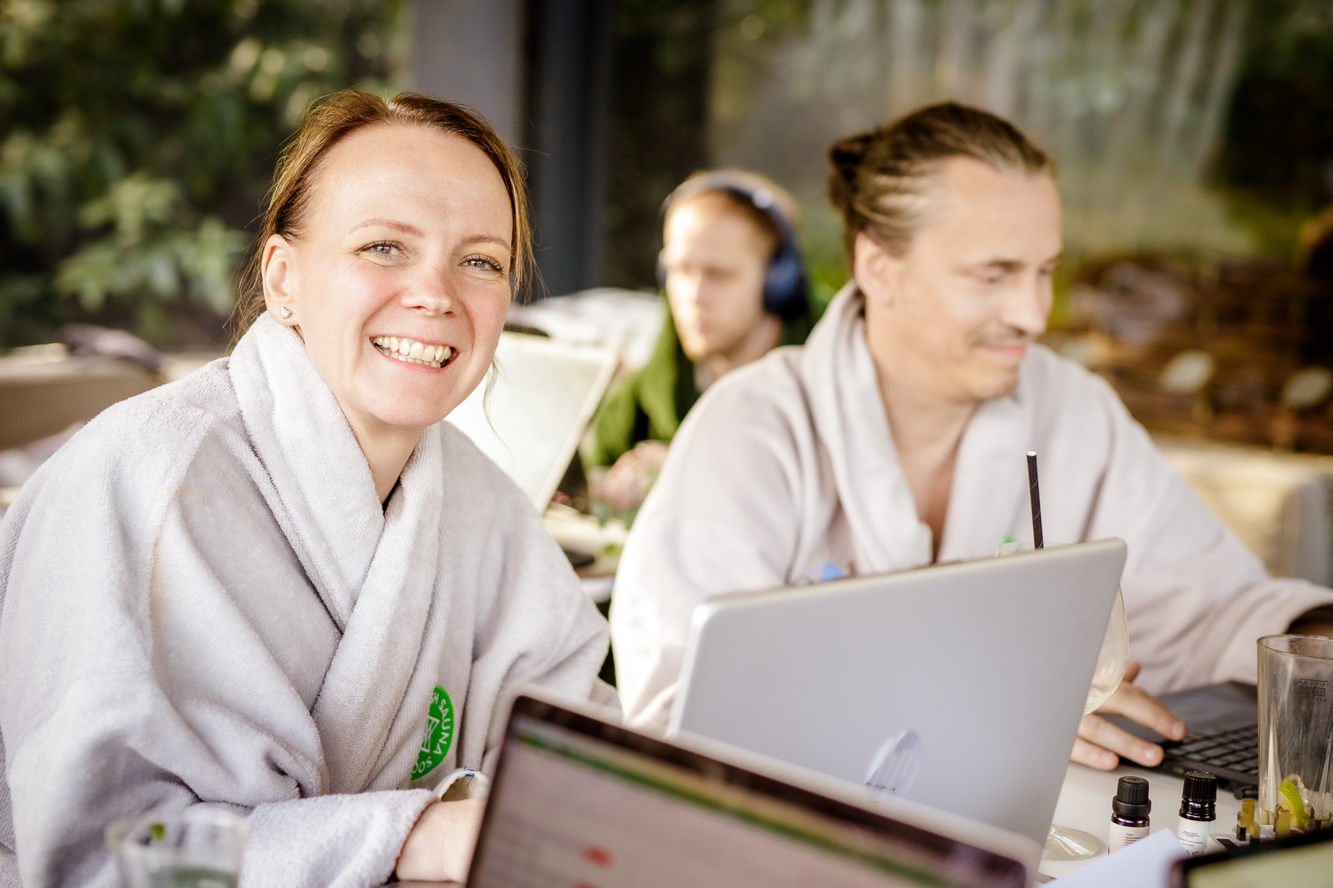 smiling woman and man in spa robes are sauna judeges