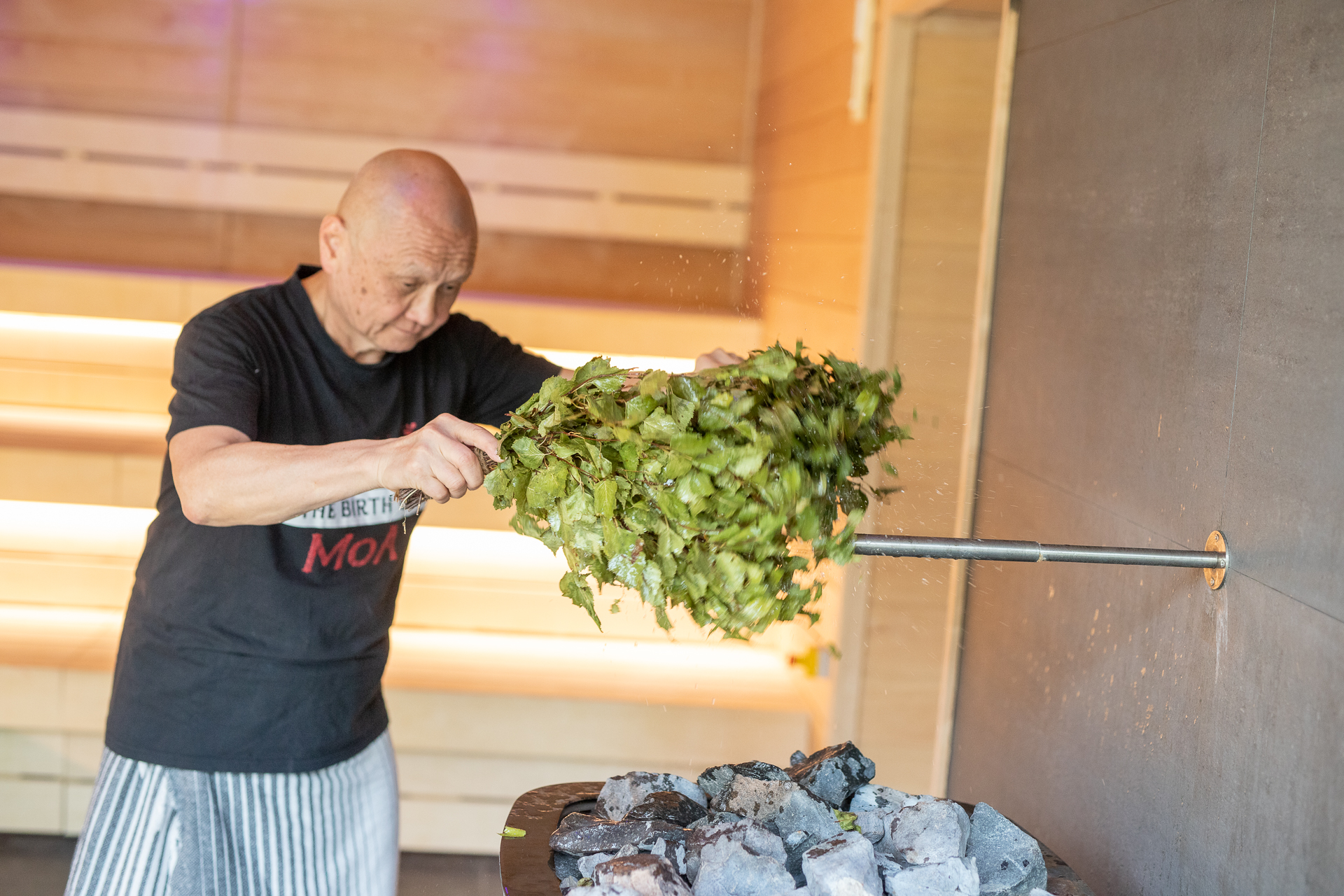 amazing sauna master uses herb whisks to increase steam in sauna