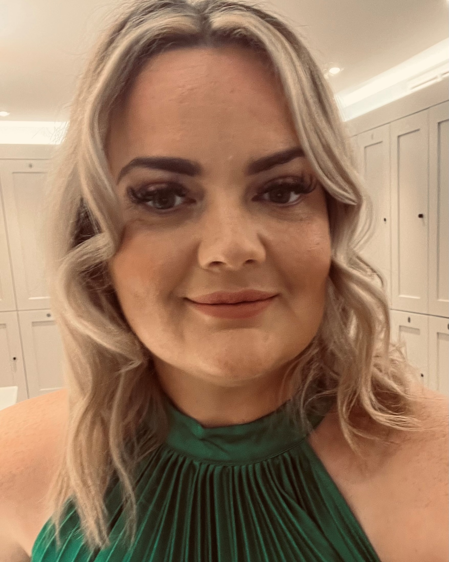 Woman with blonde hair and green top