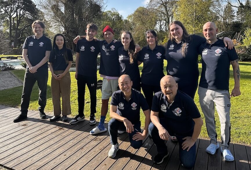 Group of people in blue shirts smiling at the camera
