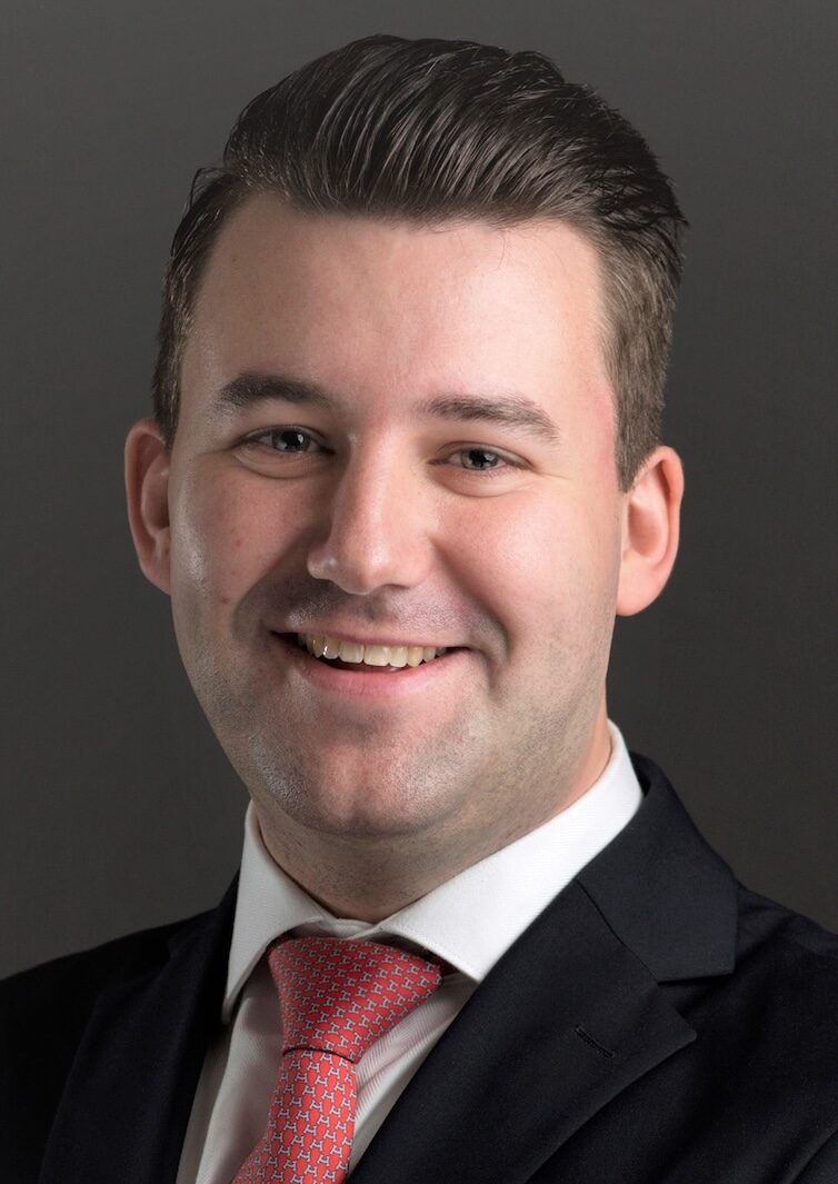 Headshot of man with arms folded