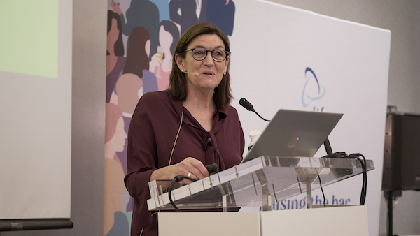 woman speaking at a lecturn