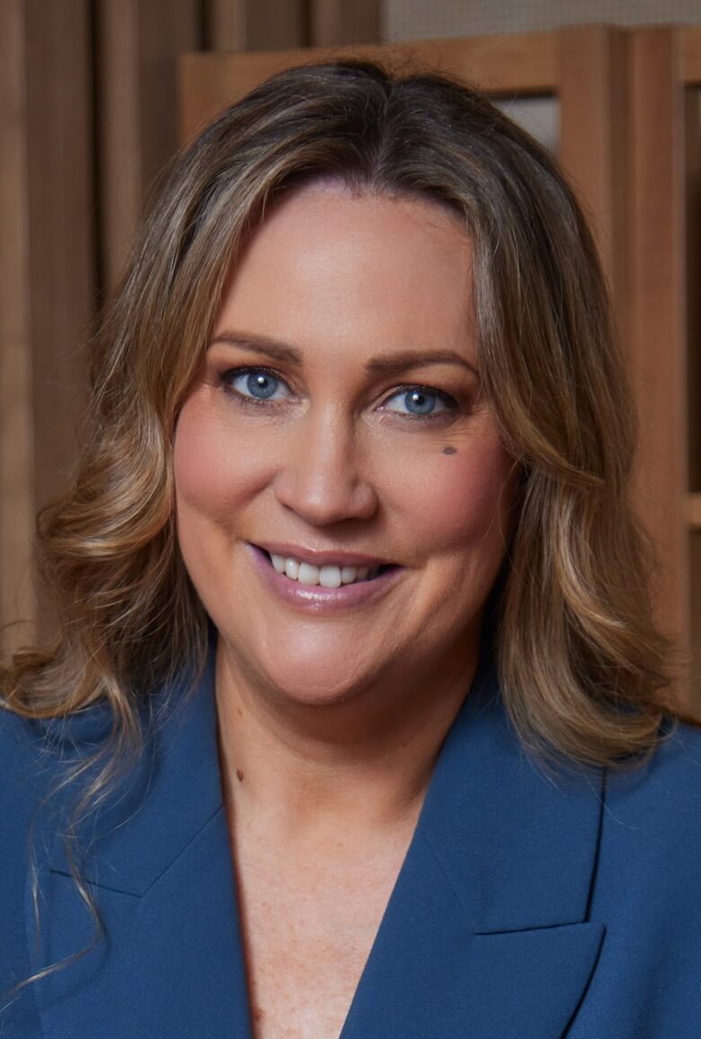 Woman in blue suit smiling at camera