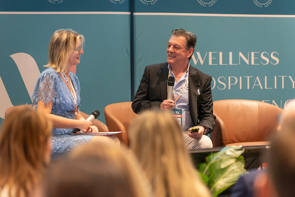 two people interviewed on a stage