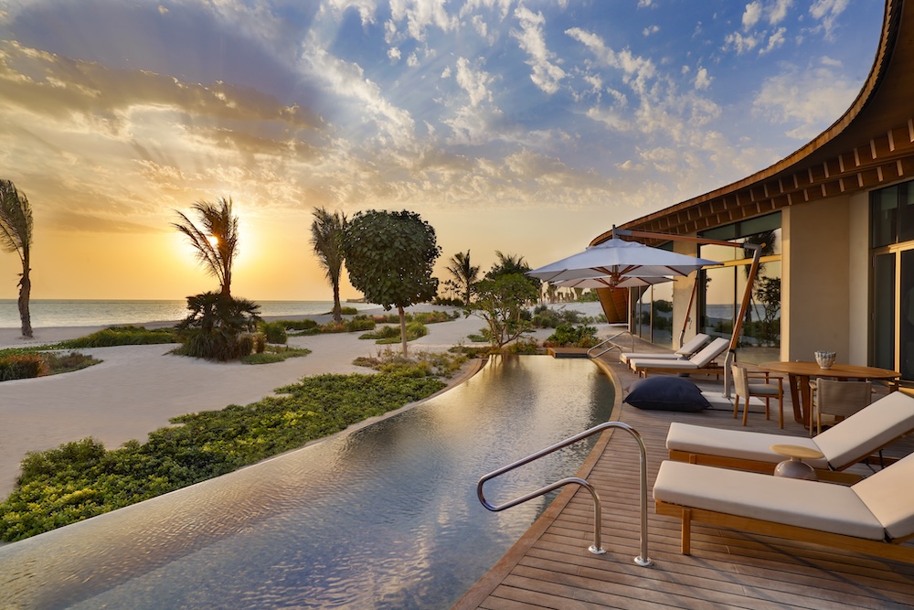 A poolside villa at sunset
